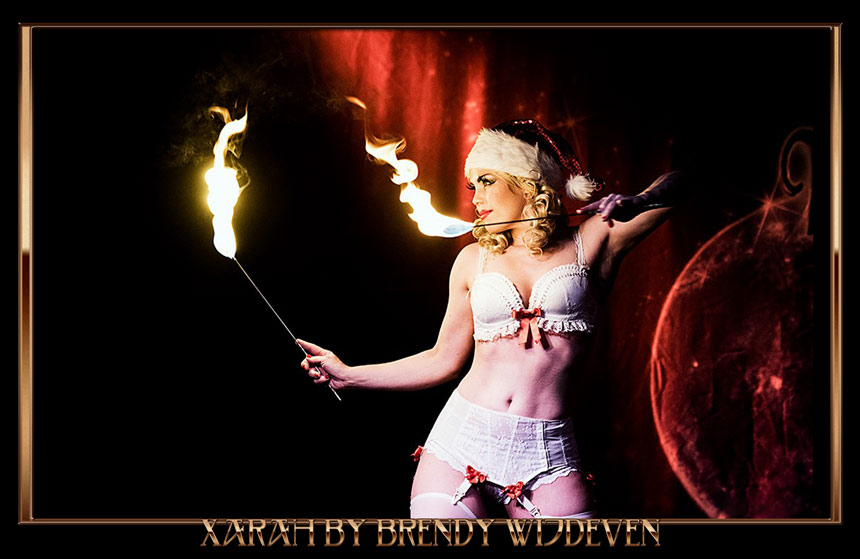 Burlesque firedancer Xarah von den Vielenregen performs her Santa Baby Xmas act at the Blue Moon Cabaret at Blue Collar Hotel in Eindhoven photographed by Brendy Wijdeven